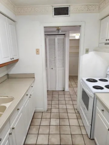 a kitchen with a stove cabinets and a refrigerator