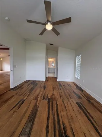 a bedroom with a bed and a ceiling fan