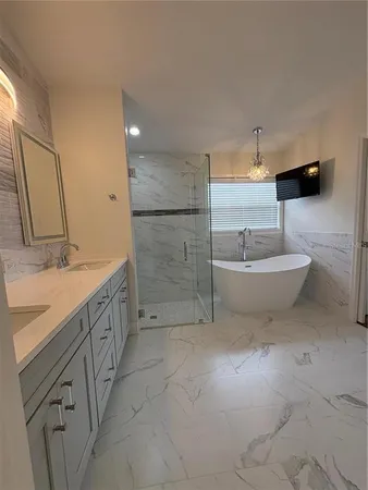 a spacious bathroom with a double vanity sink a mirror and a bathtub