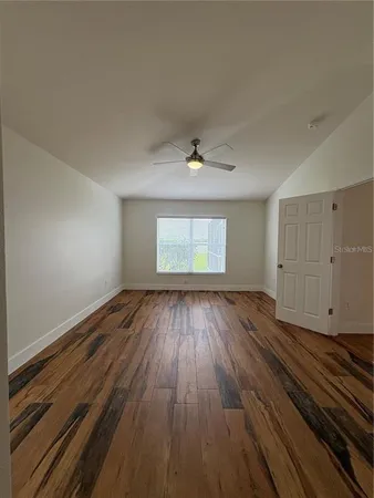 wooden floor in an empty room with a window