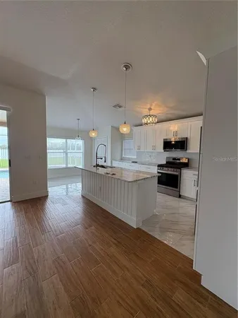 a kitchen with stainless steel appliances kitchen island wooden cabinets and granite counter tops