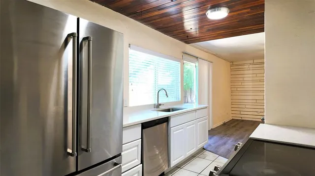 a kitchen with a sink and a refrigerator