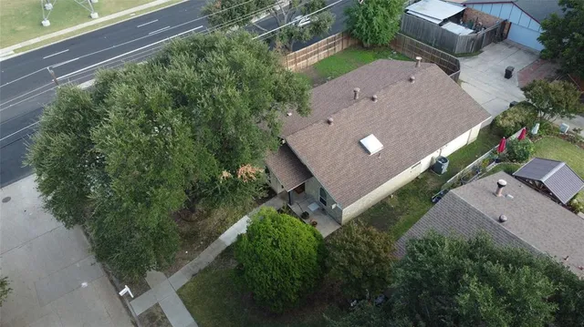 a backyard of a house with outdoor seating and barbeque oven
