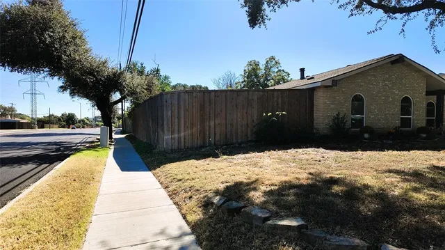 a backyard of a house with wooden fence