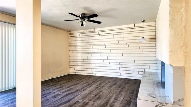 a view of a ceiling fan and wooden floor