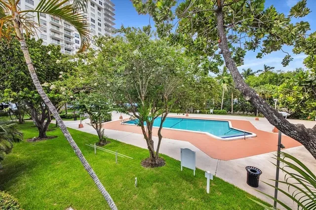 a view of yard with swimming pool and green space