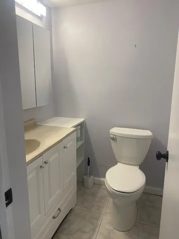 a white toilet sitting next to a bathroom sink