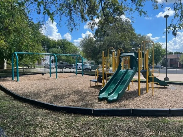 a backyard of a house with table and chairs
