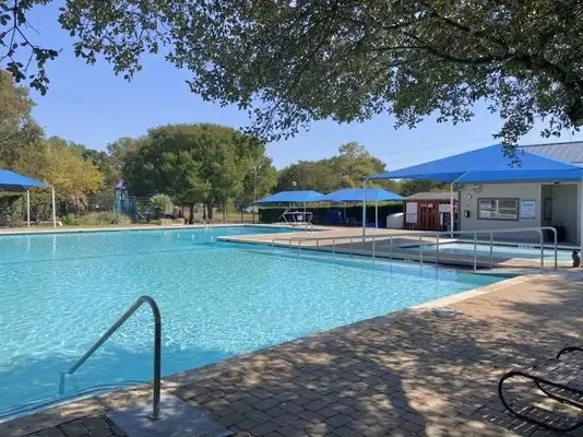 a view of a swimming pool with sitting area
