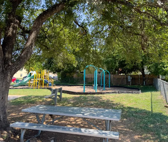 a view of a park with swings and slides