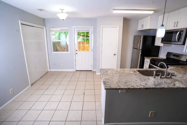 a view of a kitchen with white cabinets
