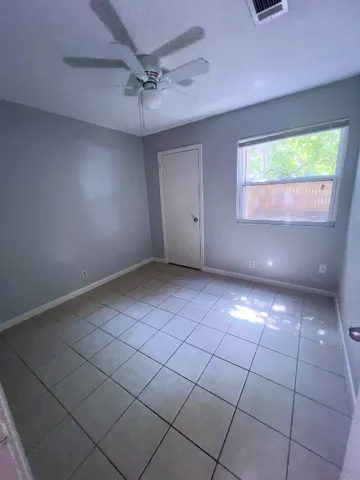 a kitchen with granite countertop white cabinets and stainless steel appliances