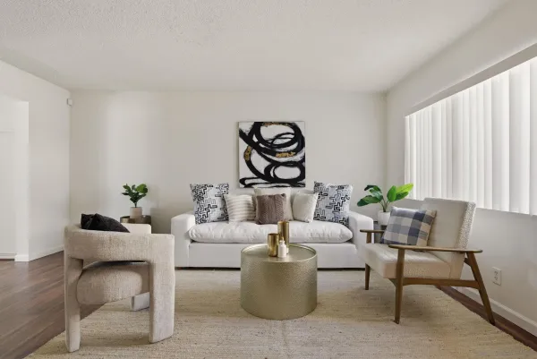 a living room with furniture and wooden floor