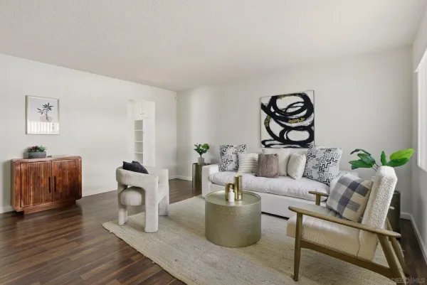 a living room with furniture and wooden floor