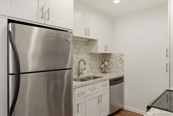 a white refrigerator freezer sitting inside of a kitchen