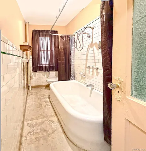 a bathroom with a bathtub and shower