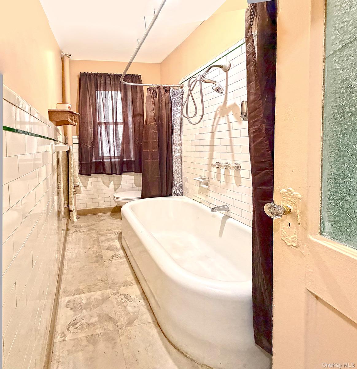 137 West 142nd Street, Unit 2D 2D Manhattan, NY 10030 - Photo 7 of 8 a bathroom with a bathtub and shower