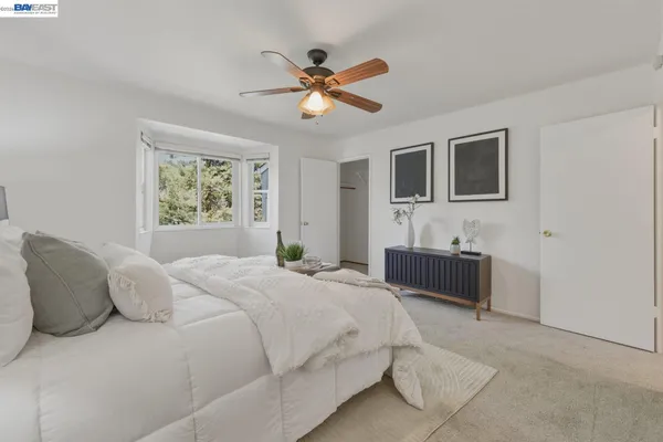 a bedroom with a large bed and a window