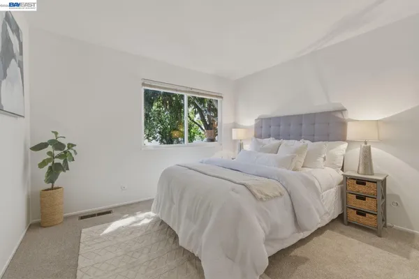 a bedroom with a bed and hallway