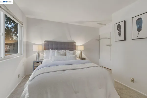 a bed room with a bed and a night stand