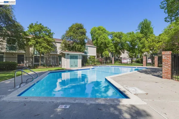swimming pool view with a outdoor seating