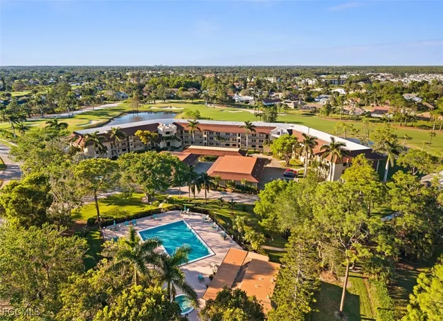 an aerial view of residential houses with outdoor space and ocean view
