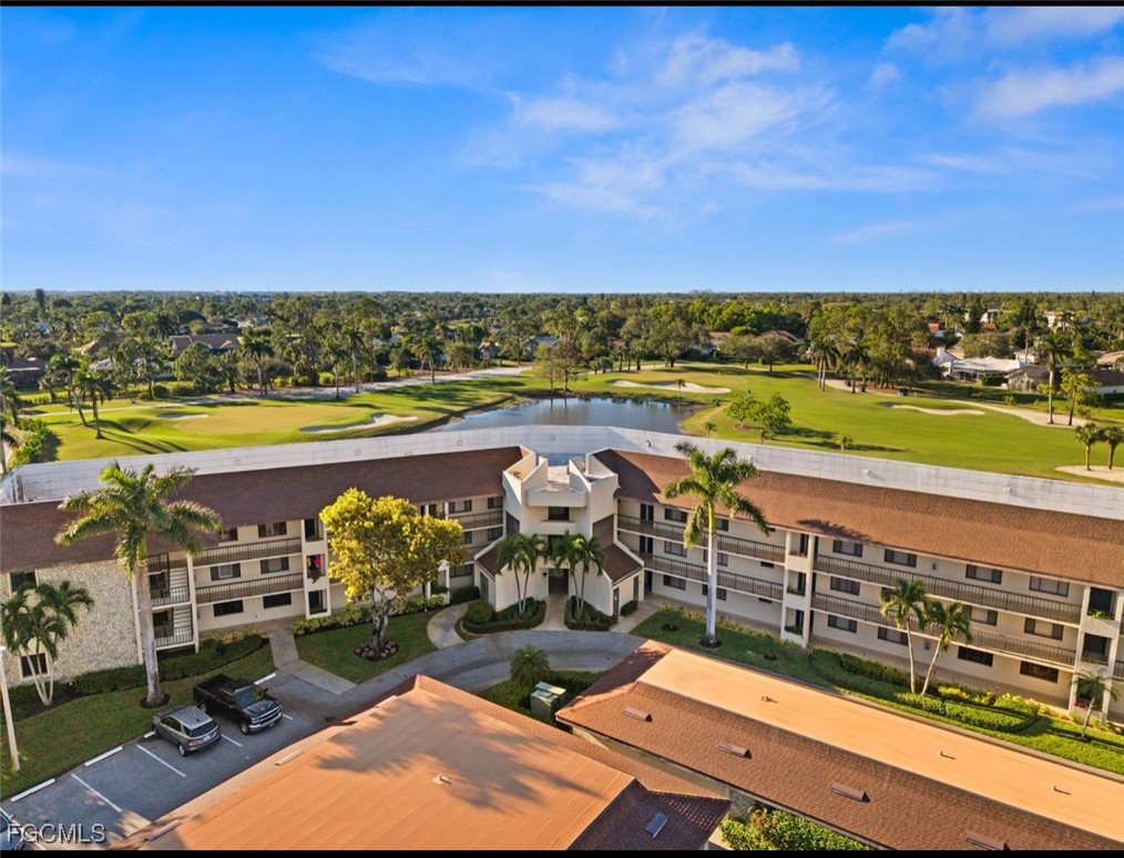 413 Augusta Boulevard, Unit 302 Naples, FL 34113 - Photo 19 of 22 a view of a swimming pool with an ocean view