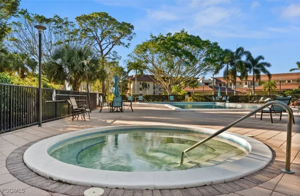 a view of a swimming pool with outdoor seating