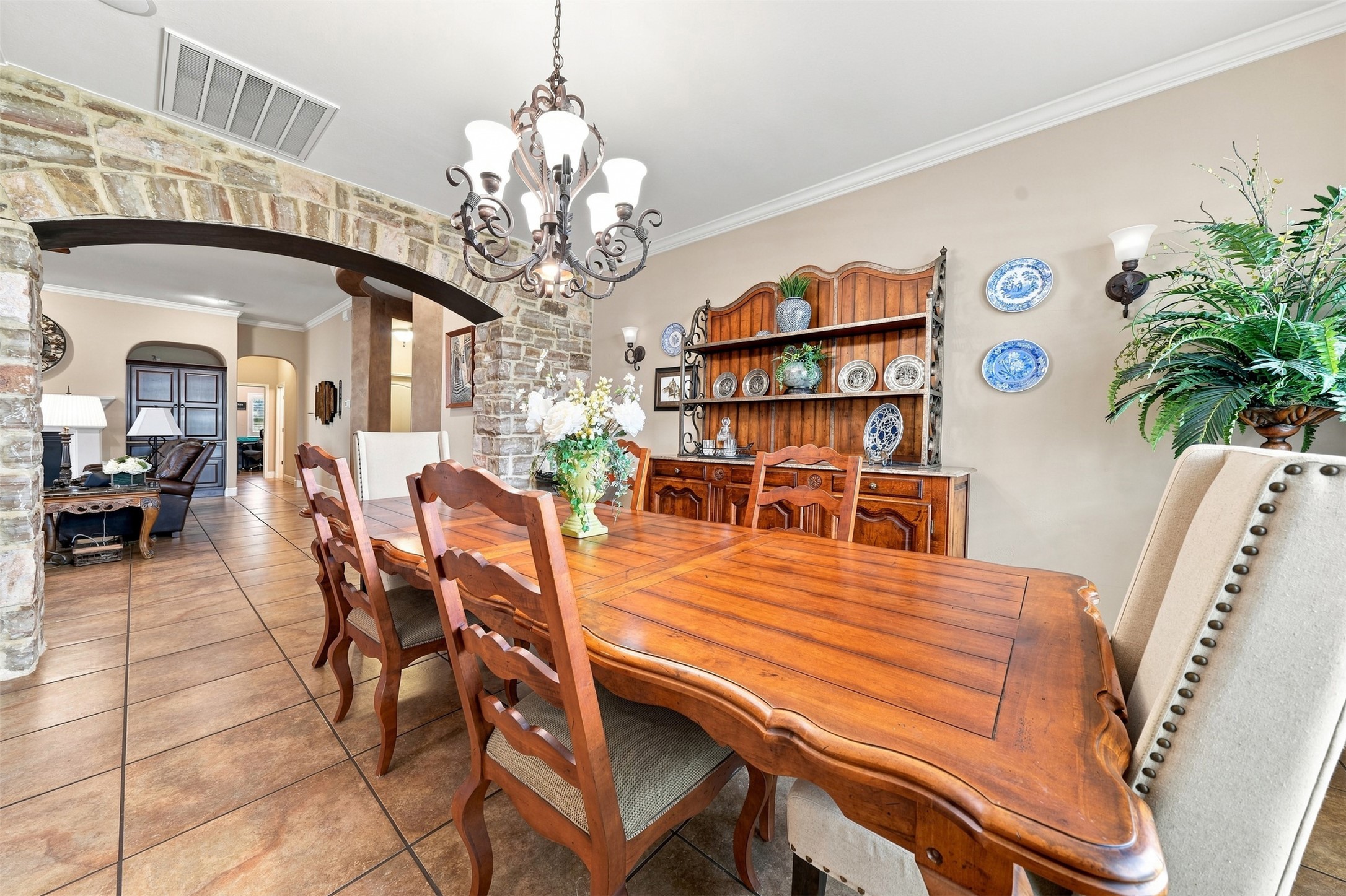 402 Ridgetop Bend Cedar Park, TX 78613 - Photo 19 of 40 An elegant stone archway frames this formal dining space with polished tile flooring.