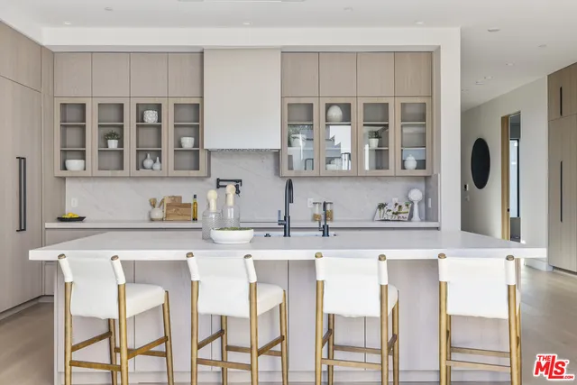 a kitchen with stainless steel appliances granite countertop a stove top oven a sink and dishwasher a refrigerator with wooden floor