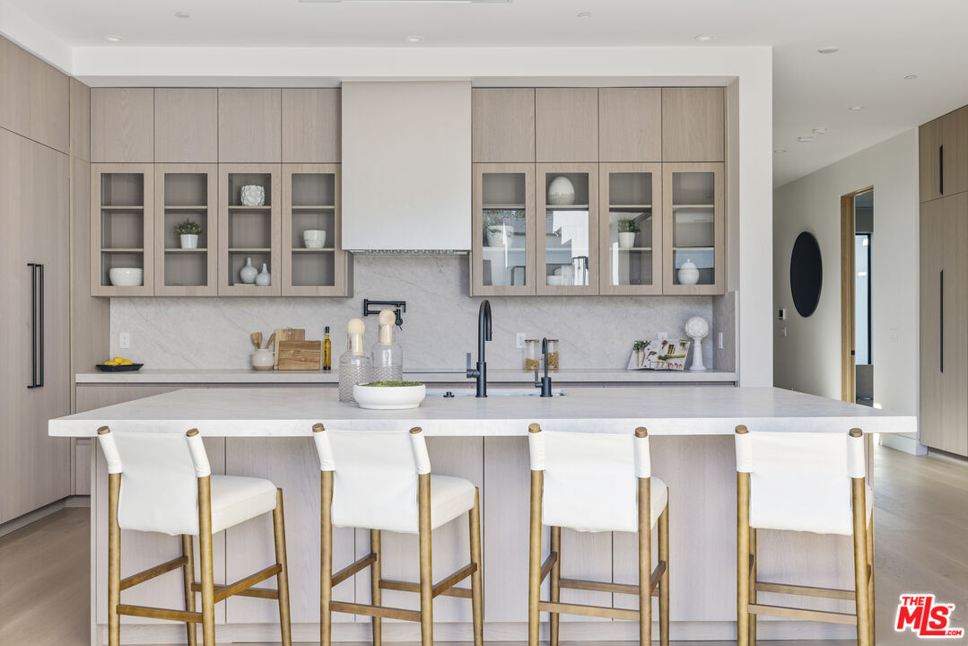 4220 Kenyon Avenue Los Angeles, CA 90066 - Photo 12 of 43 a kitchen with stainless steel appliances granite countertop a stove top oven a sink and dishwasher a refrigerator with wooden floor