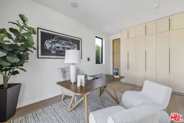 a view of a livingroom with furniture and a potted plant