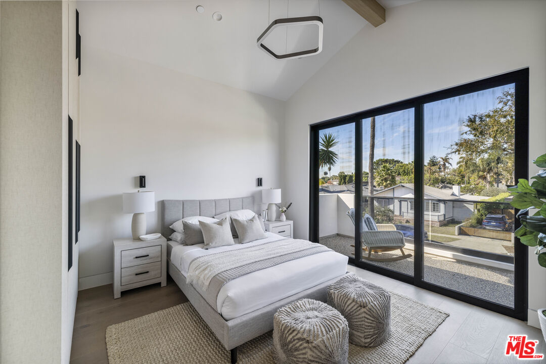 4220 Kenyon Avenue Los Angeles, CA 90066 - Photo 23 of 43 a bedroom with a large bed and a balcony view