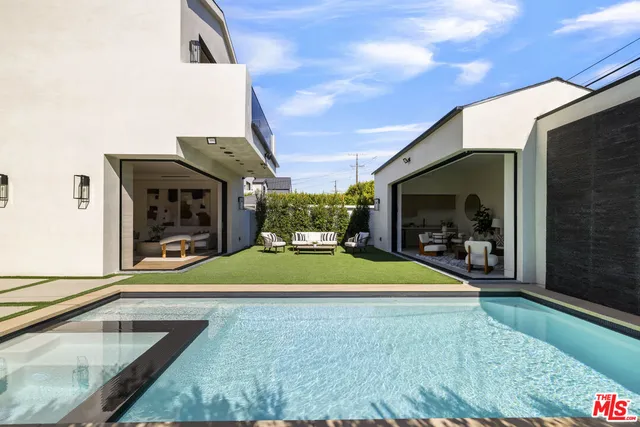 a swimming pool with outdoor seating and yard