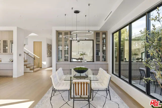 a dining room with furniture a chandelier and wooden floor