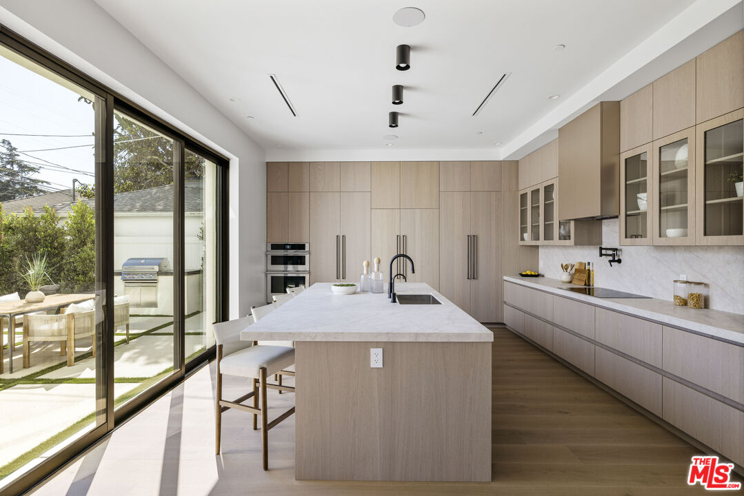 4220 Kenyon Avenue Los Angeles, CA 90066 - Photo 9 of 43 a kitchen with kitchen island a large window in it