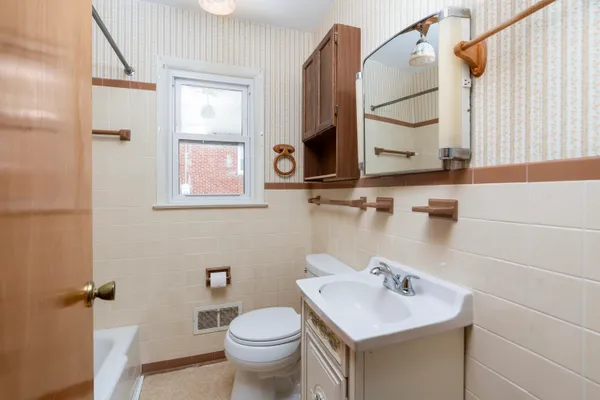 a bathroom with a sink toilet a mirror and shower
