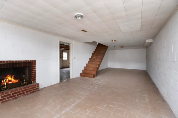 a view of an empty room with a fireplace