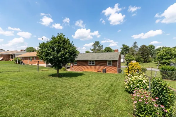 a view of a garden with a house