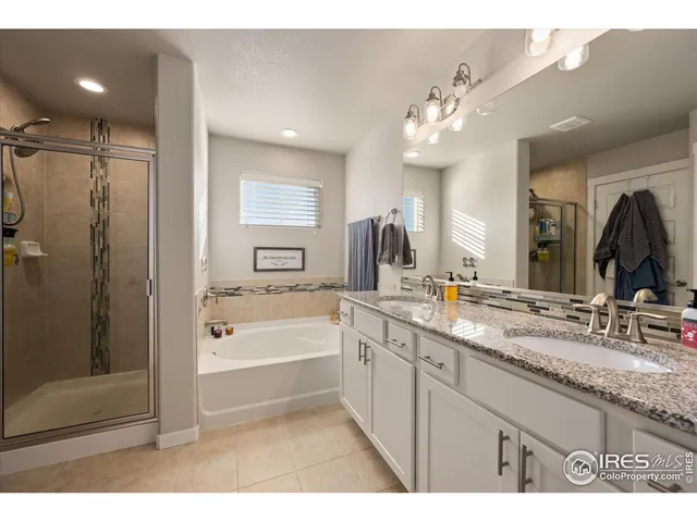 a bathroom with a granite countertop sink mirror and shower