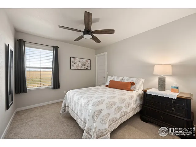 a bedroom with a bed a dresser and a window