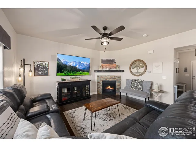 a living room with furniture a flat screen tv and a fireplace