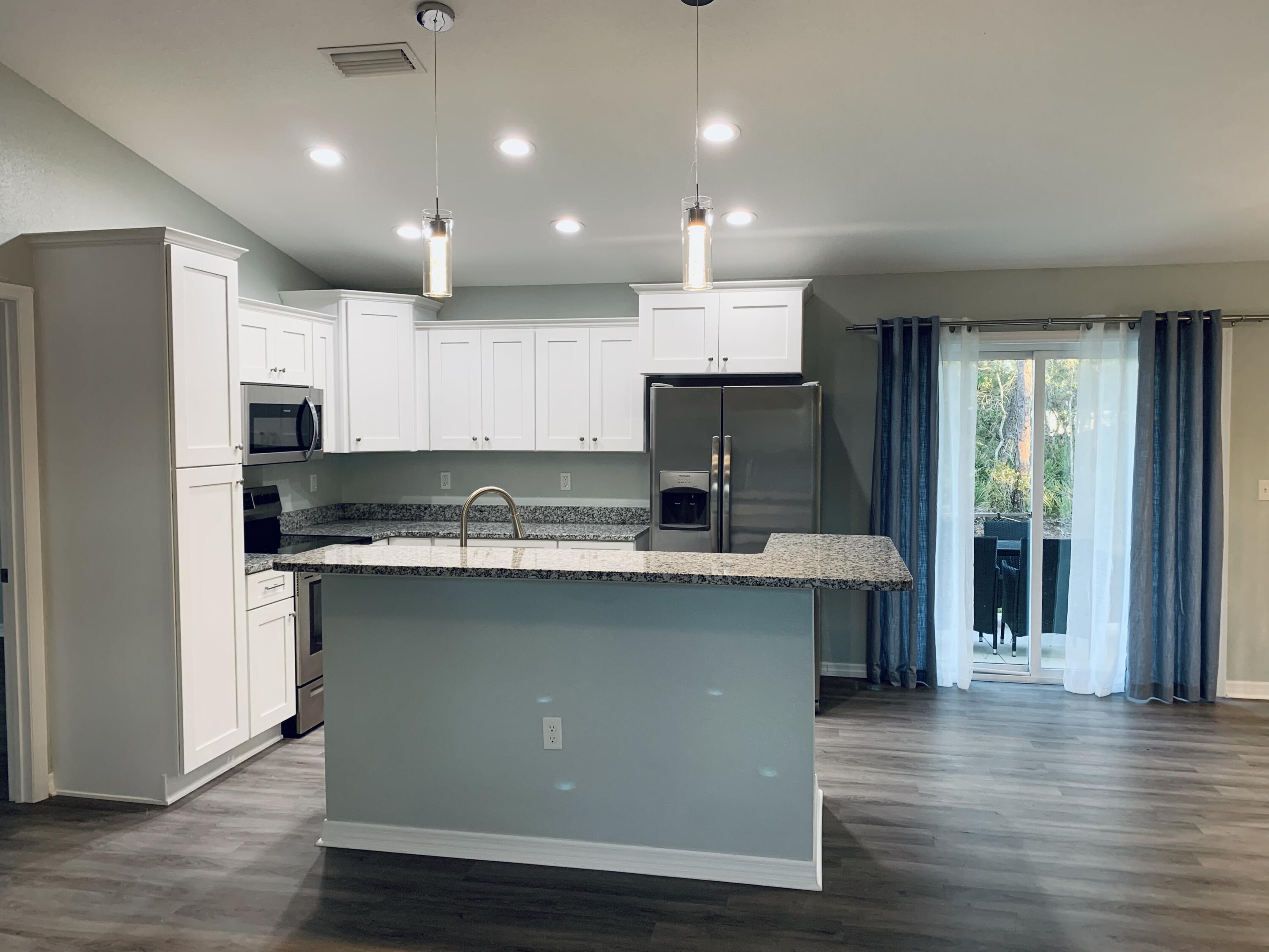 4501 Talbot Street Sebring, FL 33872 - Photo 6 of 28 a kitchen with stainless steel appliances granite countertop a sink stove and refrigerator
