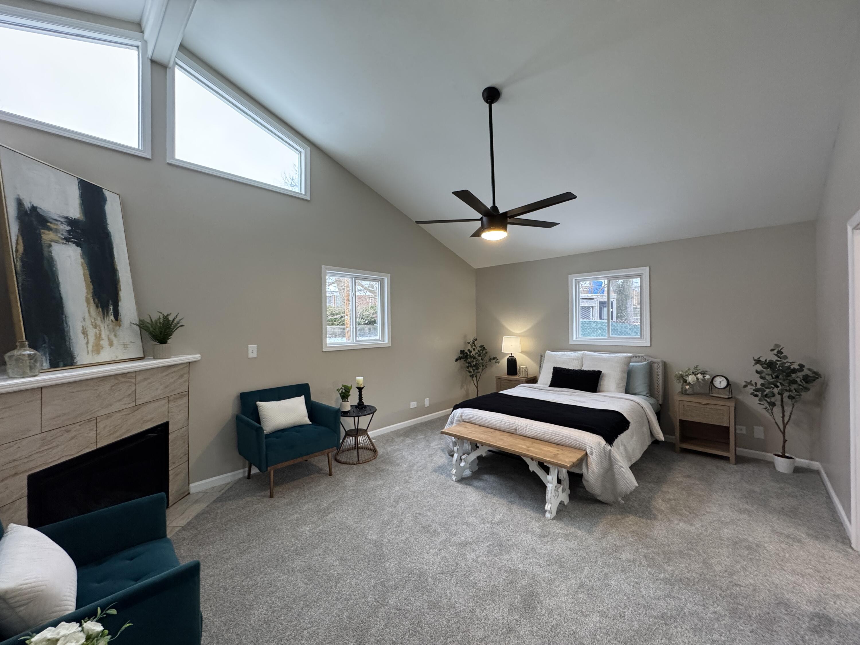 656 Montgomery Street Gary, IN 46403 - Photo 12 of 31 a spacious bedroom with a bed and a chandelier
