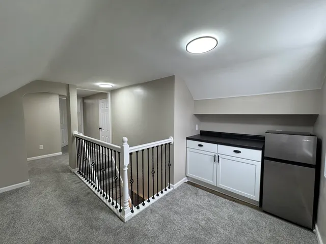 a view of a hallway to rooms and stairs