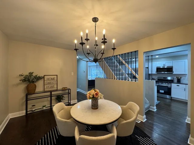 a dining room with furniture and wooden floor