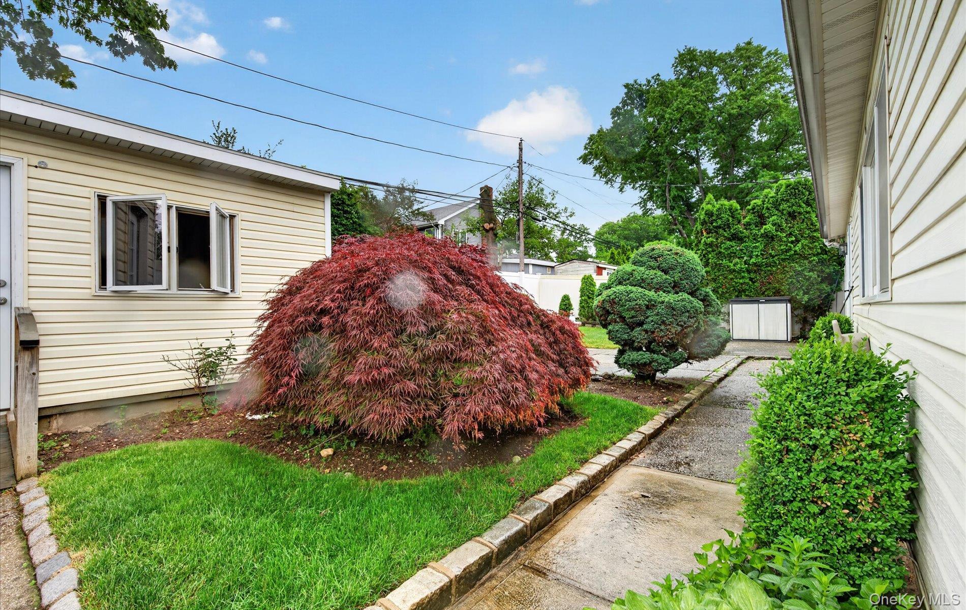 24 Purdue Road Glen Cove, NY 11542 - Photo 7 of 41 a view of a backyard with potted plants