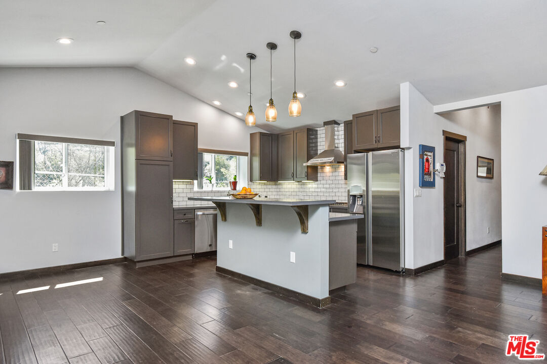 2447 Stonyvale Road Tujunga, CA 91042 - Photo 4 of 33 a kitchen with stainless steel appliances a refrigerator sink and microwave