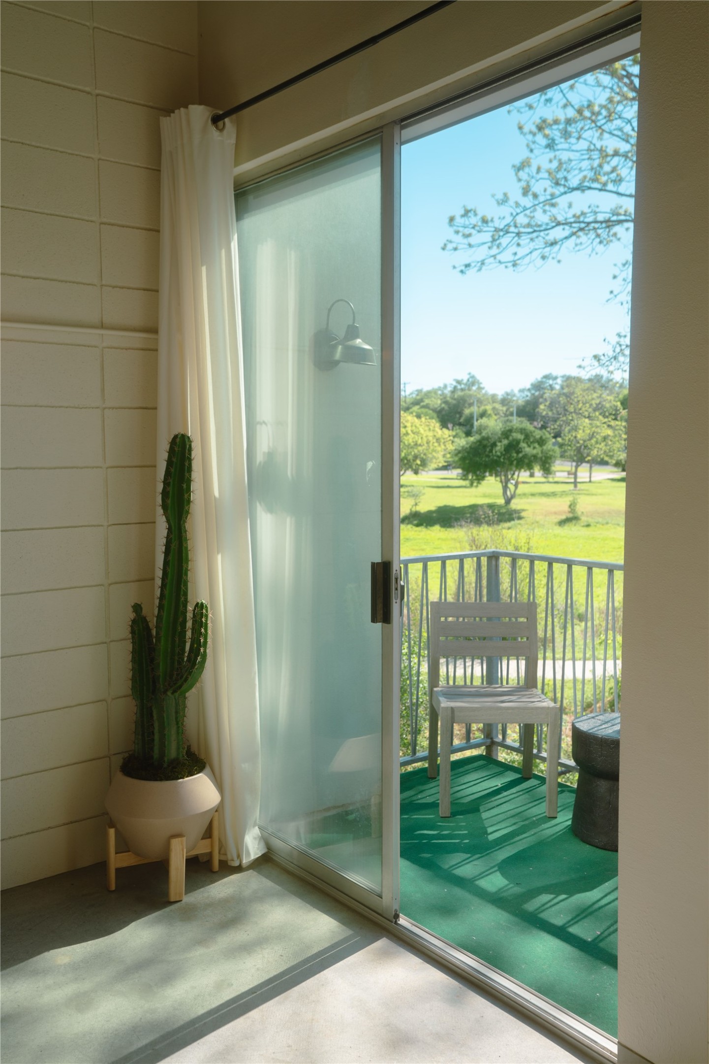 4801 South Congress Avenue, Unit H5 Austin, TX 78745 - Photo 26 of 39 Doorway featuring concrete floors and view of golf course