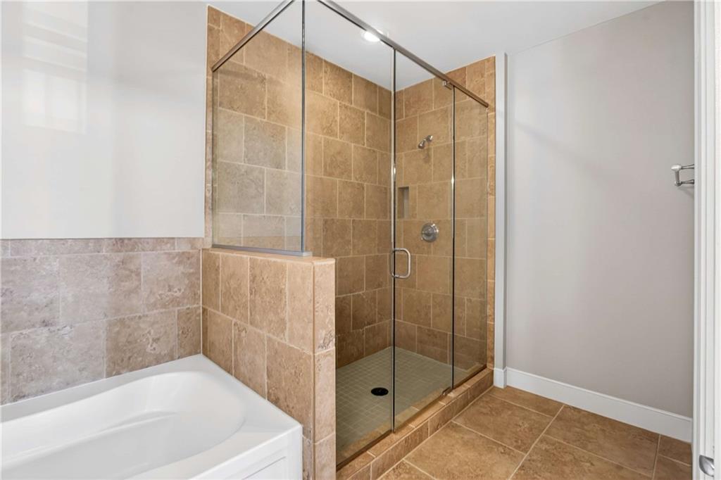 201 West Ponce De Leon Avenue, Unit 702 Decatur, GA 30030 - Photo 20 of 41 a bathroom with a shower and a bathtub